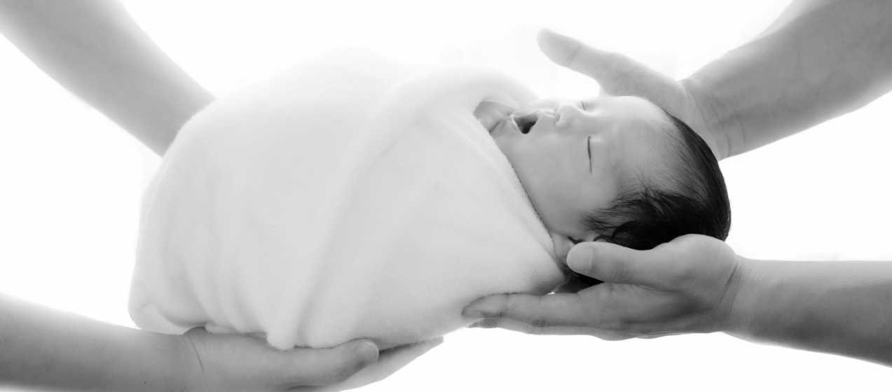 モノクロ写真のあくびをする新生児
